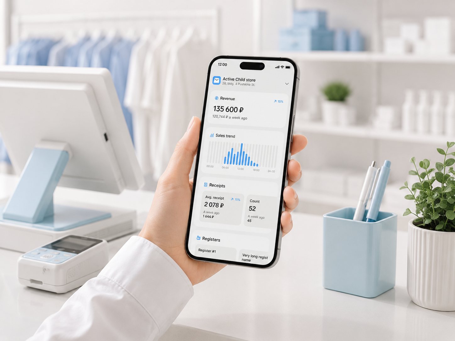 A shop assistant checking revenue, sales trend and registers in the app at the counter